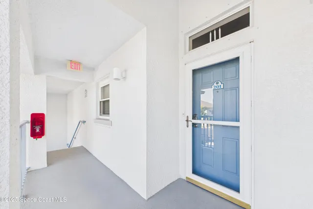 a view of a room with wooden floor and white walls
