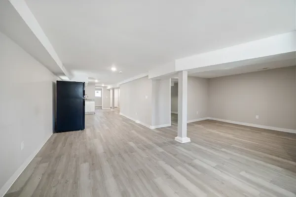 a view of empty room with wooden floor
