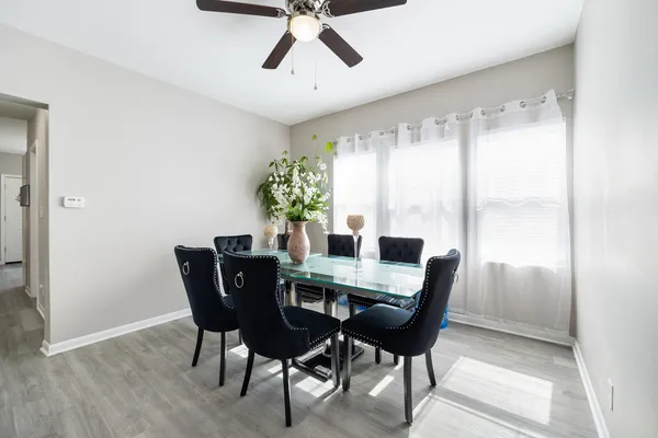 a view of a dining room with furniture window and wooden floor