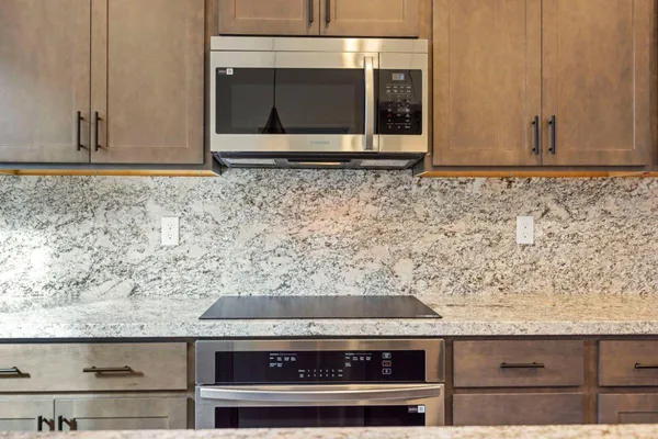 a kitchen with stainless steel appliances granite countertop a sink and dishwasher