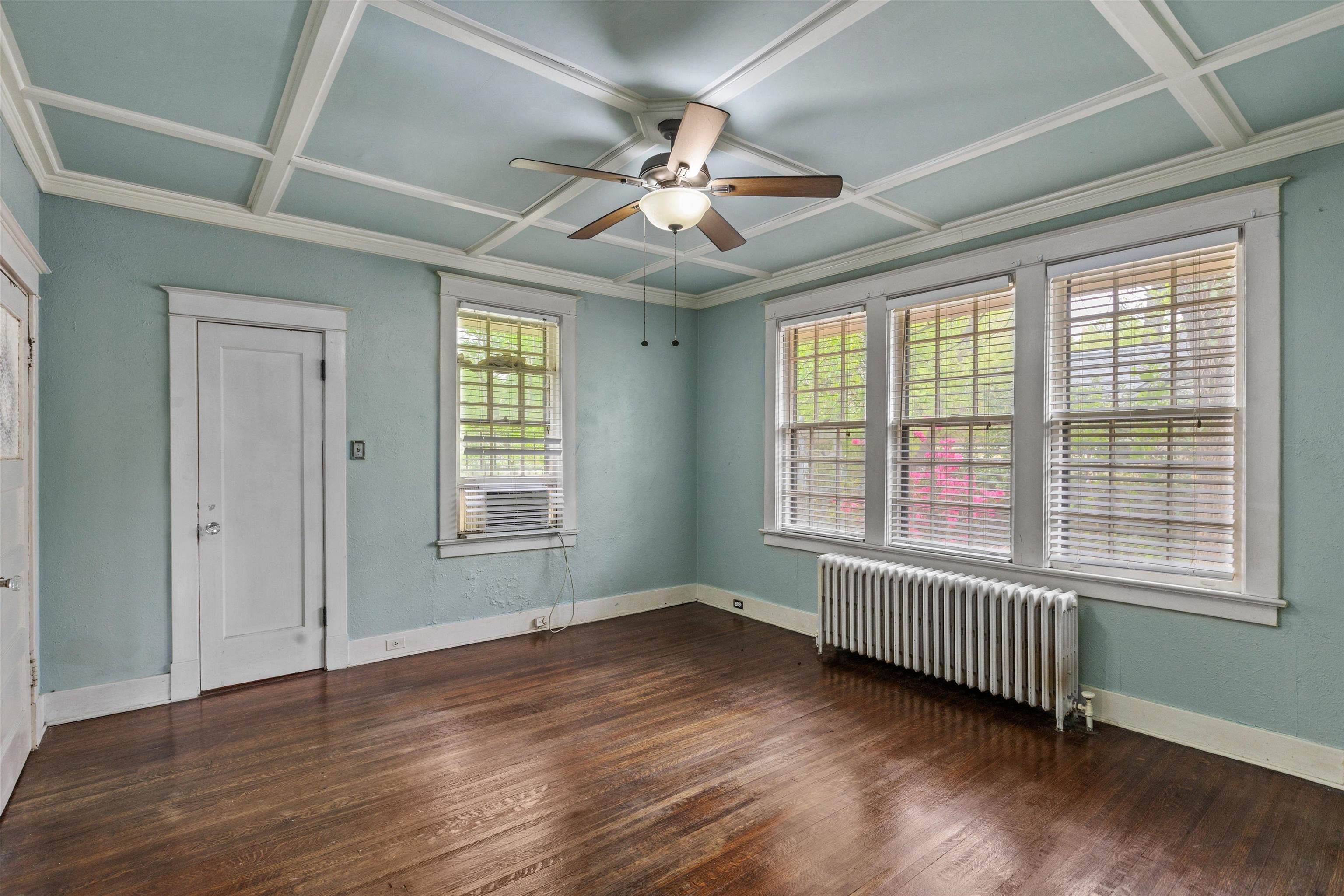 569 North Trezevant Street Memphis, TN 38112 - Photo 12 of 26 a view of an empty room with wooden floor and a window