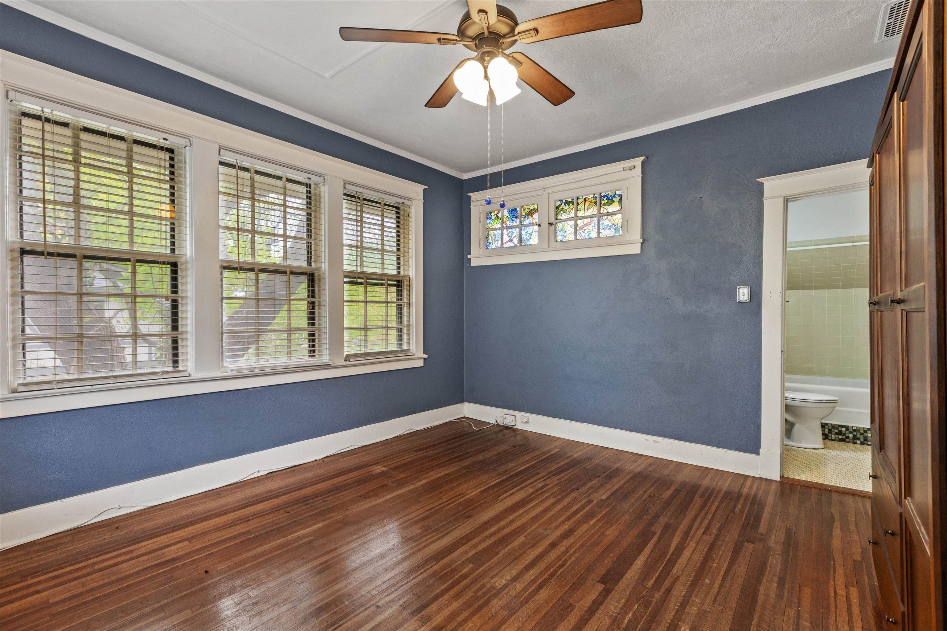 569 North Trezevant Street Memphis, TN 38112 - Photo 18 of 26 a view of an empty room with wooden floor and a window