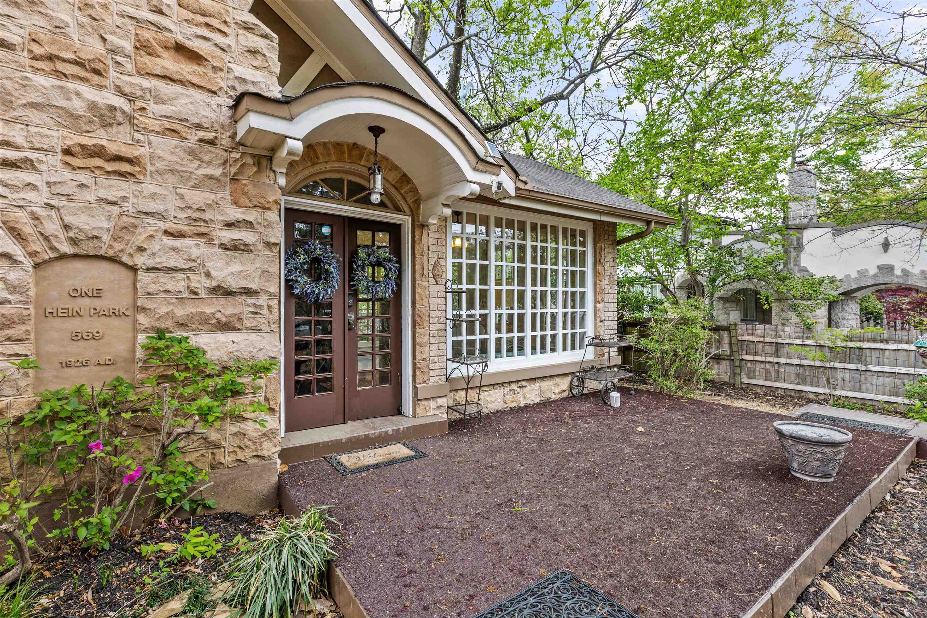 569 North Trezevant Street Memphis, TN 38112 - Photo 2 of 26 a view of a house with a small yard and plants