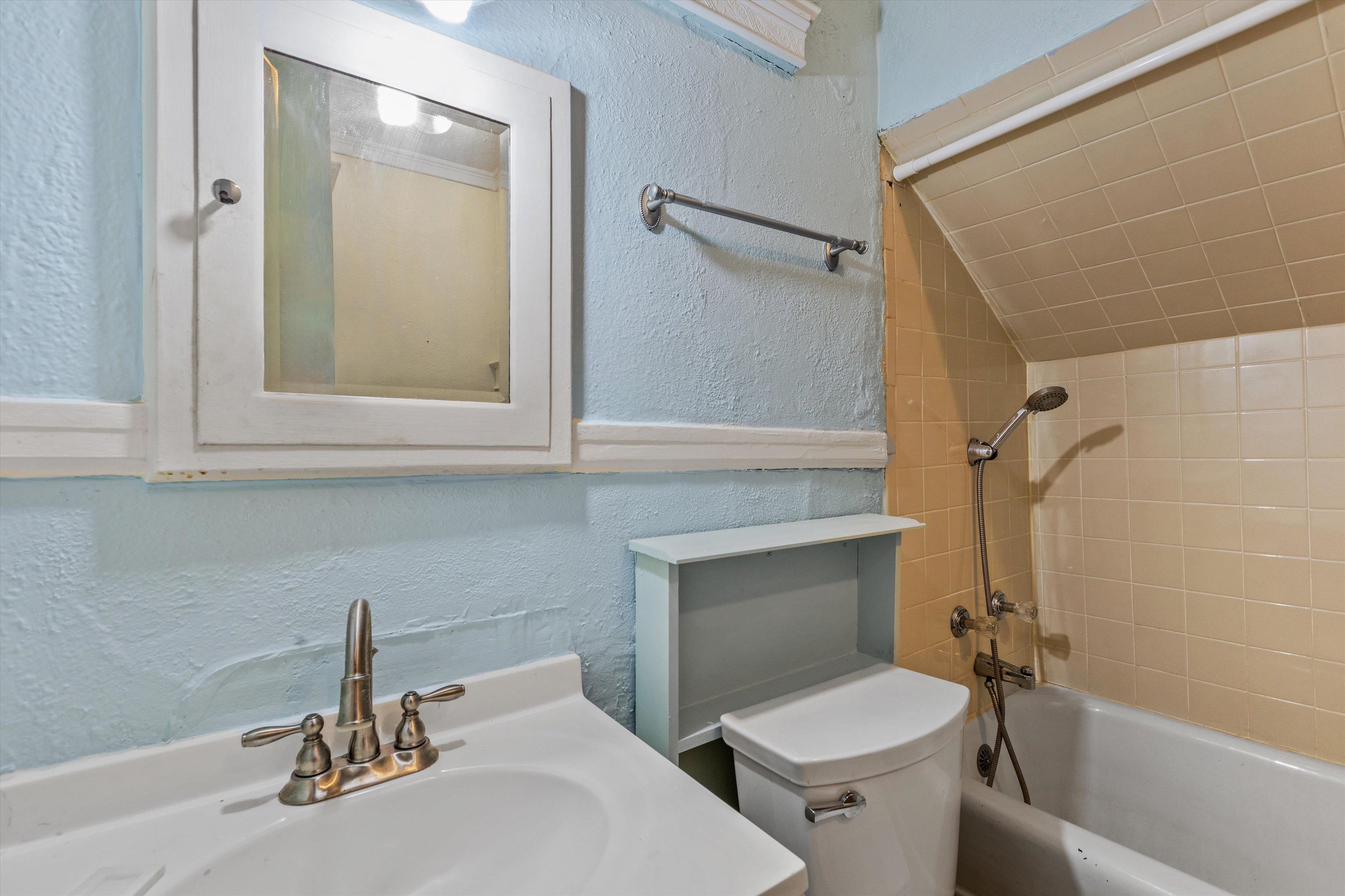 569 North Trezevant Street Memphis, TN 38112 - Photo 21 of 26 a bathroom with a sink and a mirror