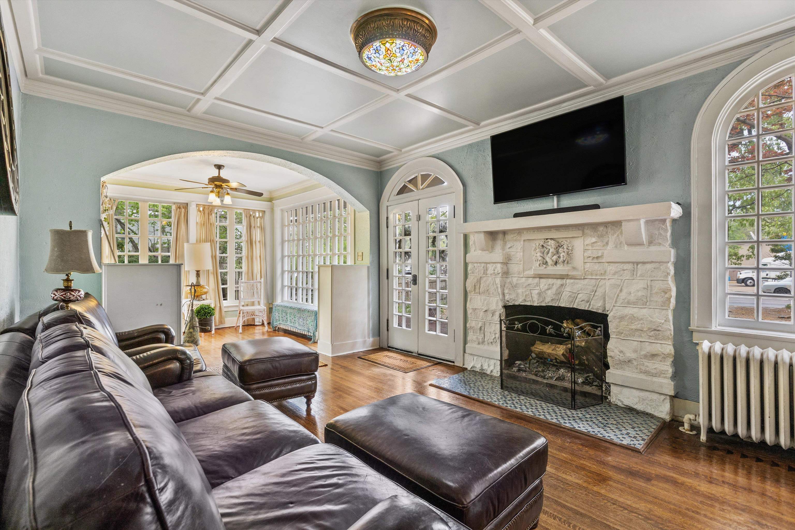 569 North Trezevant Street Memphis, TN 38112 - Photo 4 of 26 a living room with furniture a flat screen tv and a fireplace
