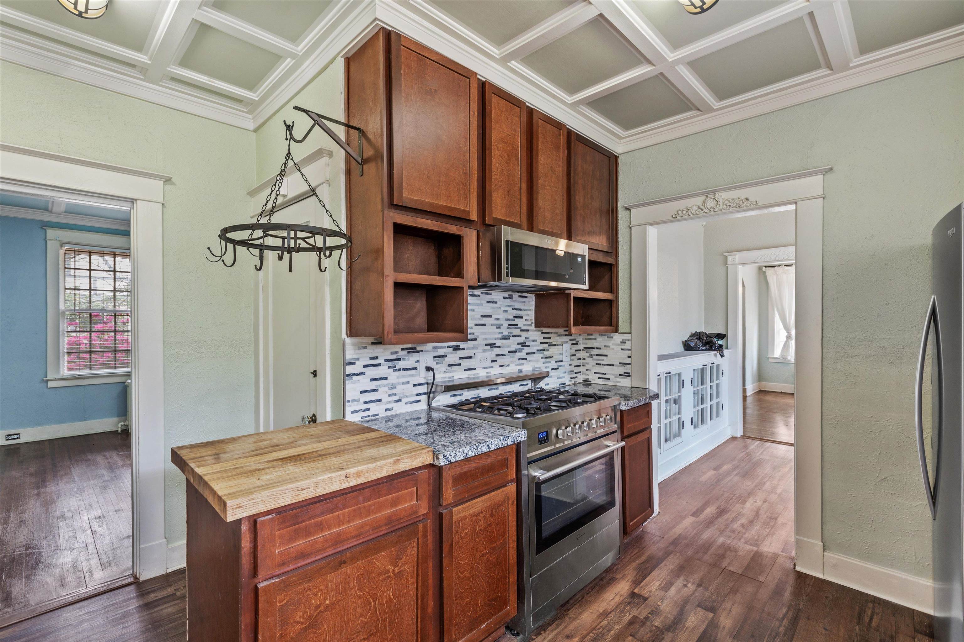 569 North Trezevant Street Memphis, TN 38112 - Photo 10 of 26 a kitchen with stainless steel appliances granite countertop a stove and a refrigerator