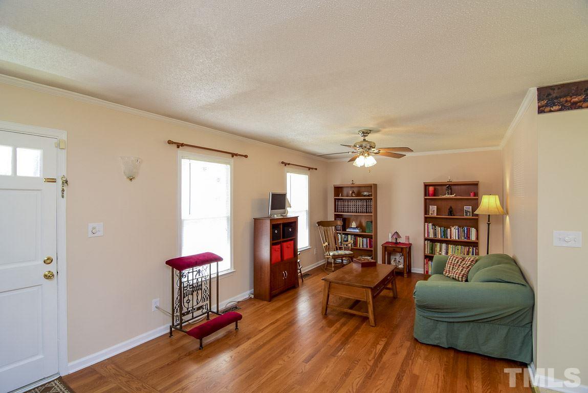 3921 Live Oak Road Raleigh, NC 27604 - Photo 14 of 25 a living room with furniture and a wooden floor