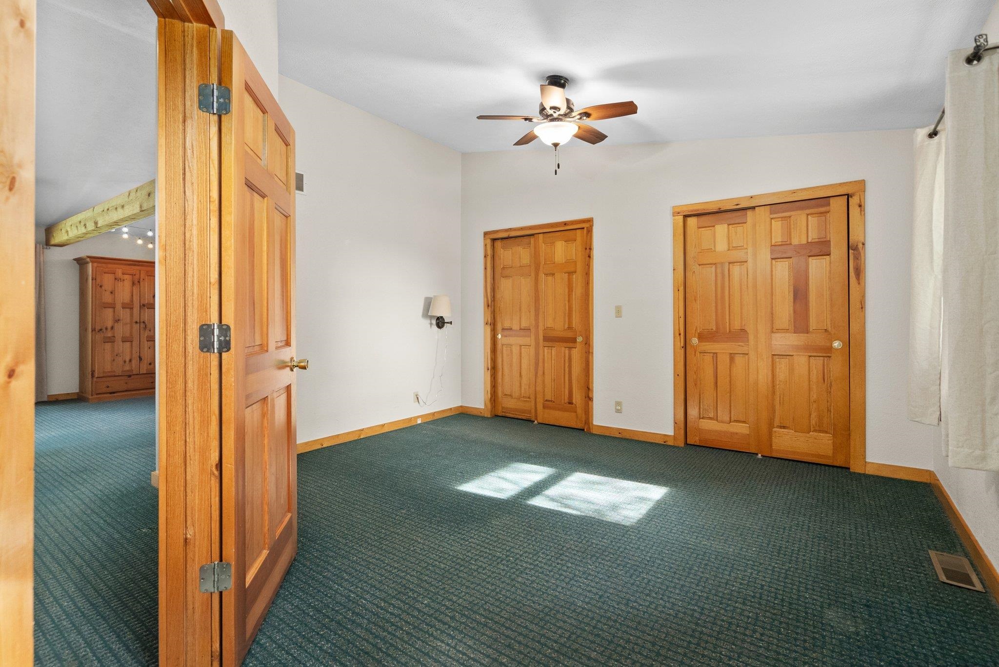 14657 Prairie Road Rockton, IL 61072 - Photo 23 of 55 a view of an empty room with chandelier fan and a bathroom