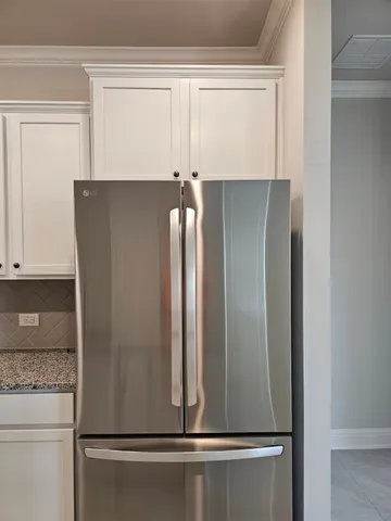 a view of a refrigerator in kitchen
