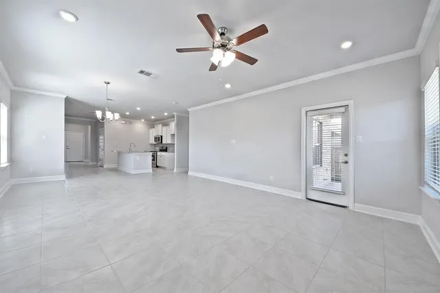 a view of an empty room and a ceiling fan
