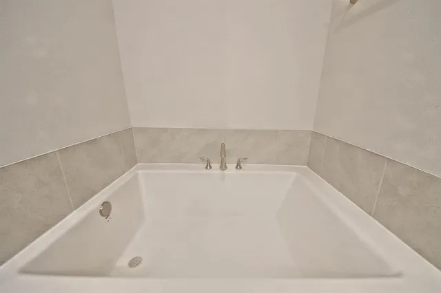 a white bath tub sitting in a bathroom