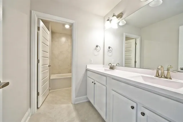 a bathroom with a double vanity sink mirror and double