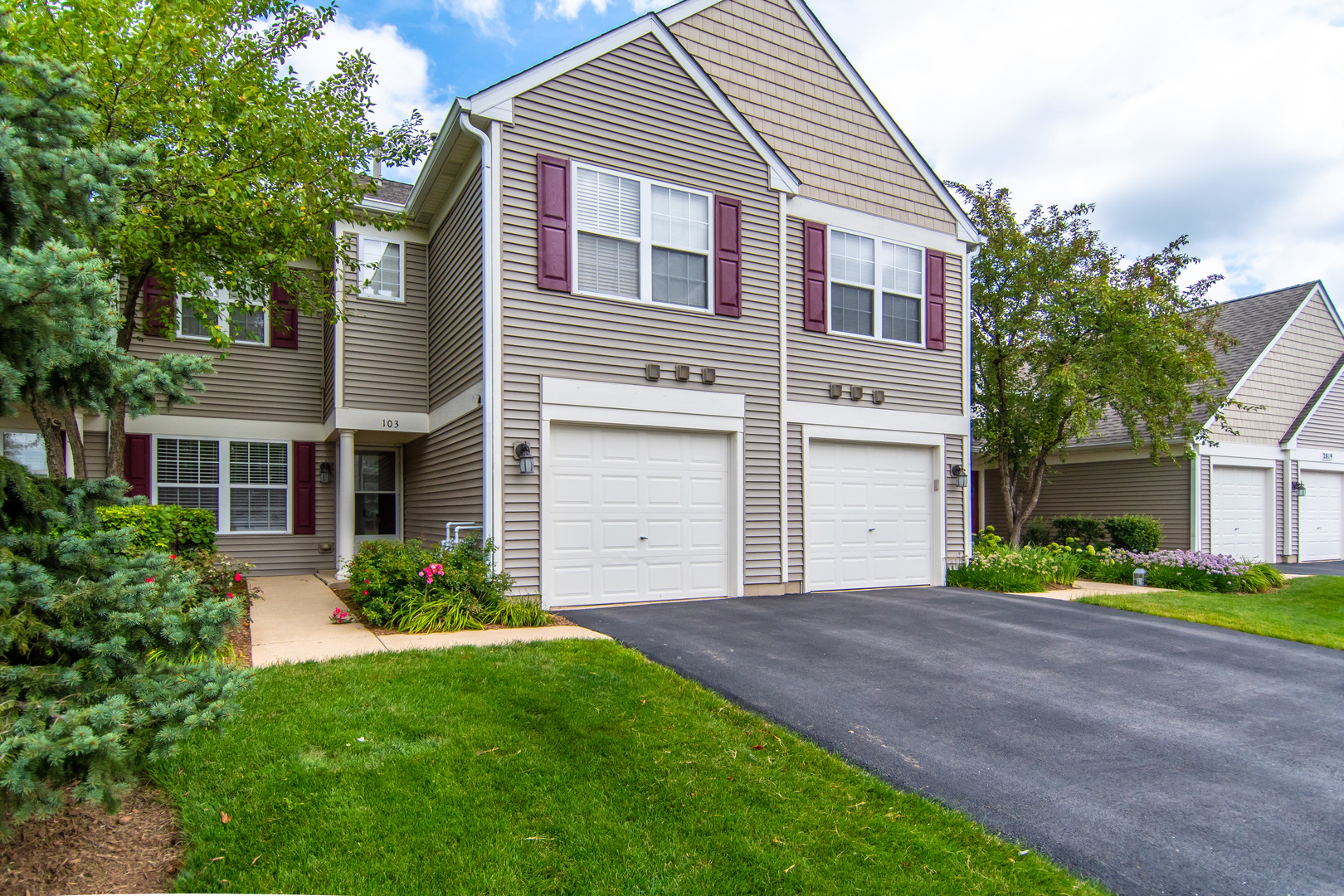 2819 Rutland Circle, Unit 103 Naperville, IL 60564 - Photo 1 of 25 a front view of a house with a yard and garage