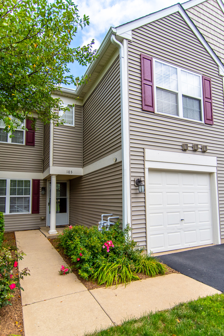2819 Rutland Circle, Unit 103 Naperville, IL 60564 - Photo 2 of 25 a front view of a house with garden