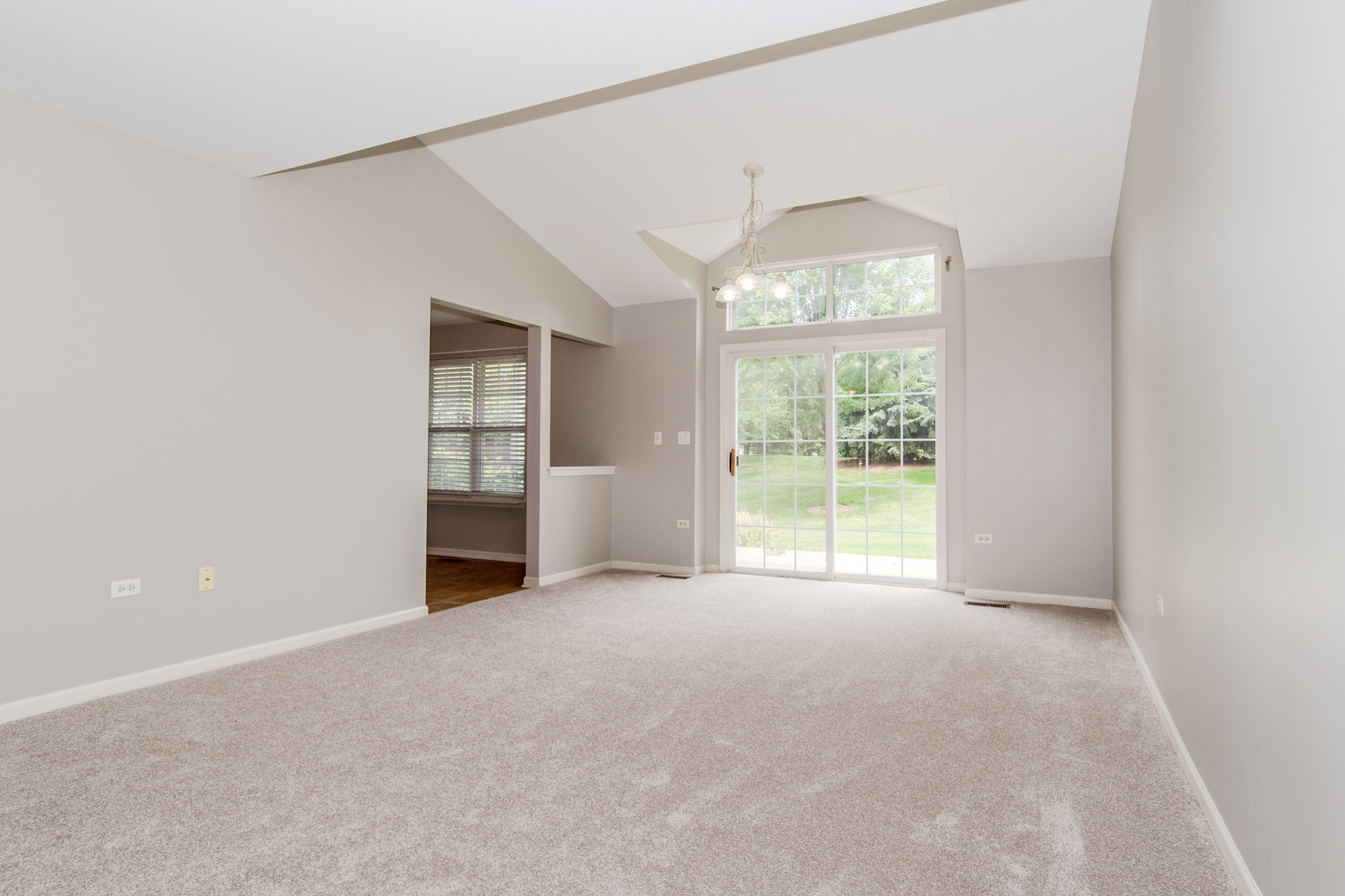 2819 Rutland Circle, Unit 103 Naperville, IL 60564 - Photo 4 of 25 an empty room with windows and city view