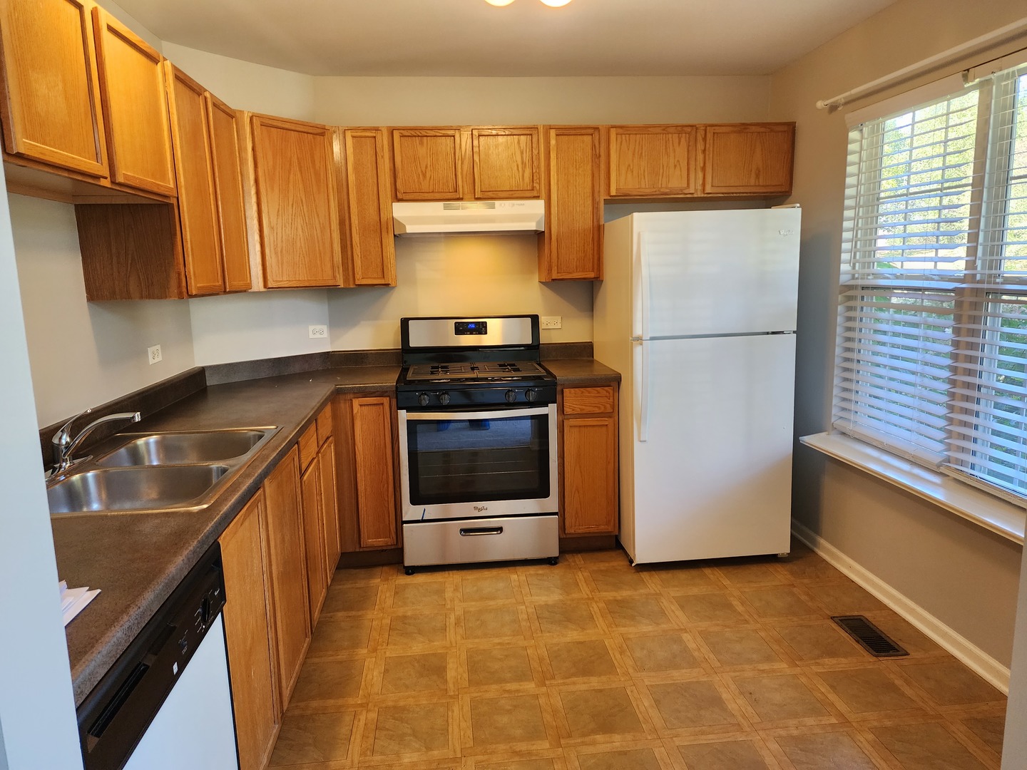 2819 Rutland Circle, Unit 103 Naperville, IL 60564 - Photo 5 of 25 a kitchen with a sink a stove and refrigerator