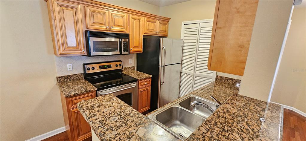 a kitchen with wooden cabinets and a stove top oven