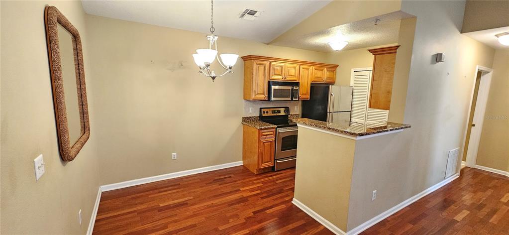 4340 South Kirkman Road, Unit 912 Orlando, FL 32811 - Photo 3 of 21 a view of a room with wooden floor and electronic appliances