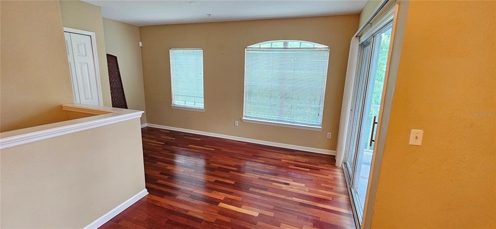 4340 South Kirkman Road, Unit 912 Orlando, FL 32811 - Photo 5 of 21 a view of hallway with window and wooden floor