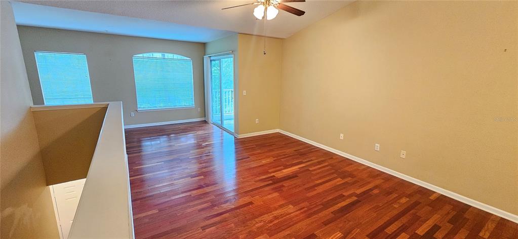 4340 South Kirkman Road, Unit 912 Orlando, FL 32811 - Photo 7 of 21 wooden floor in an empty room with a window