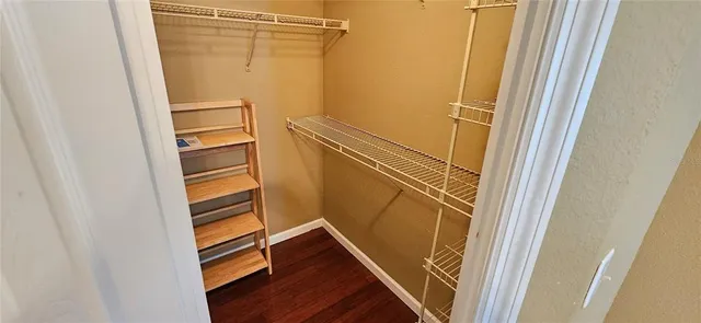 a view of walk in closet with empty racks