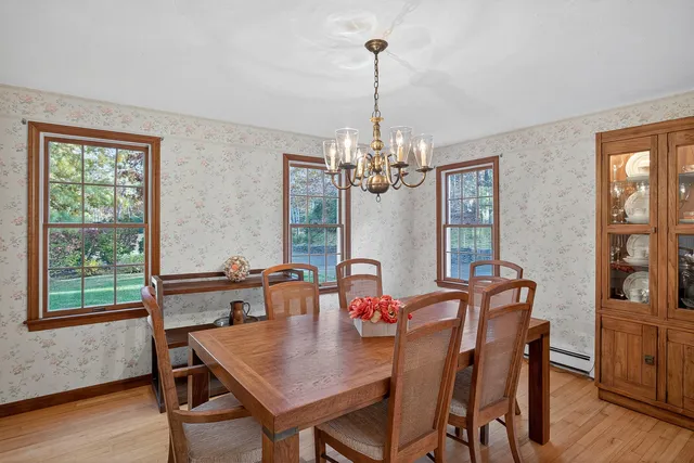 a view of a dining room with furniture window and wooden floor
