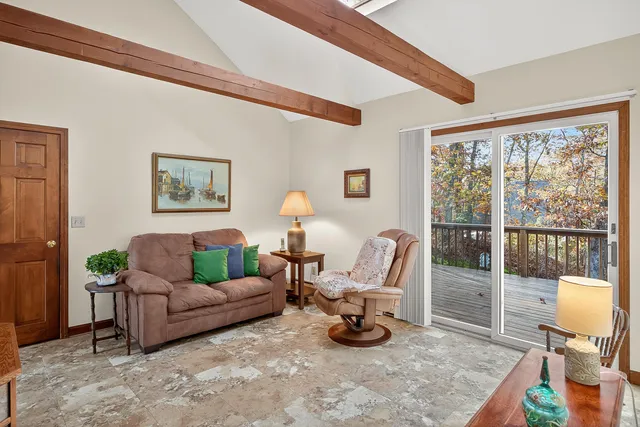 a living room with furniture and a floor to ceiling window