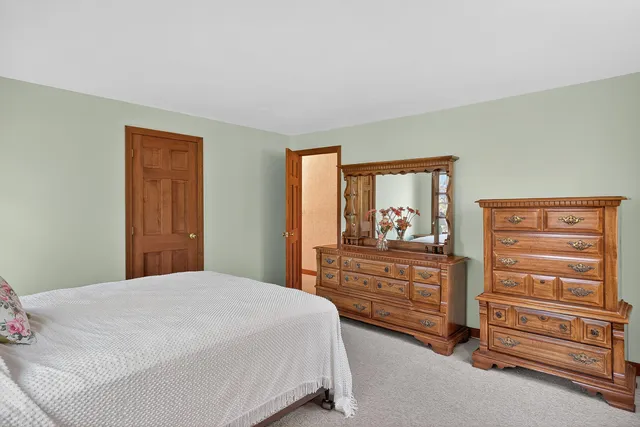 a bedroom with a bed and a dresser