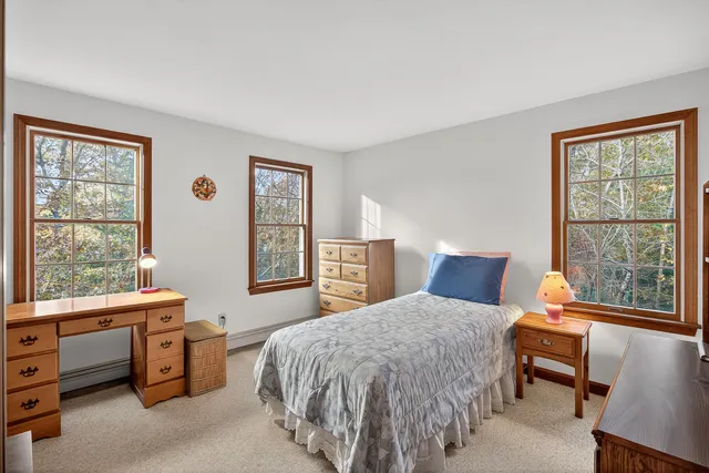 a bed room with a bed and a window