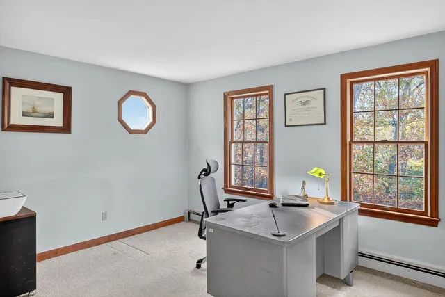 a workspace with furniture and wall paintings