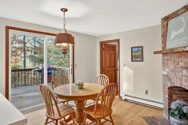 a dining room with furniture a chandelier and wooden floor