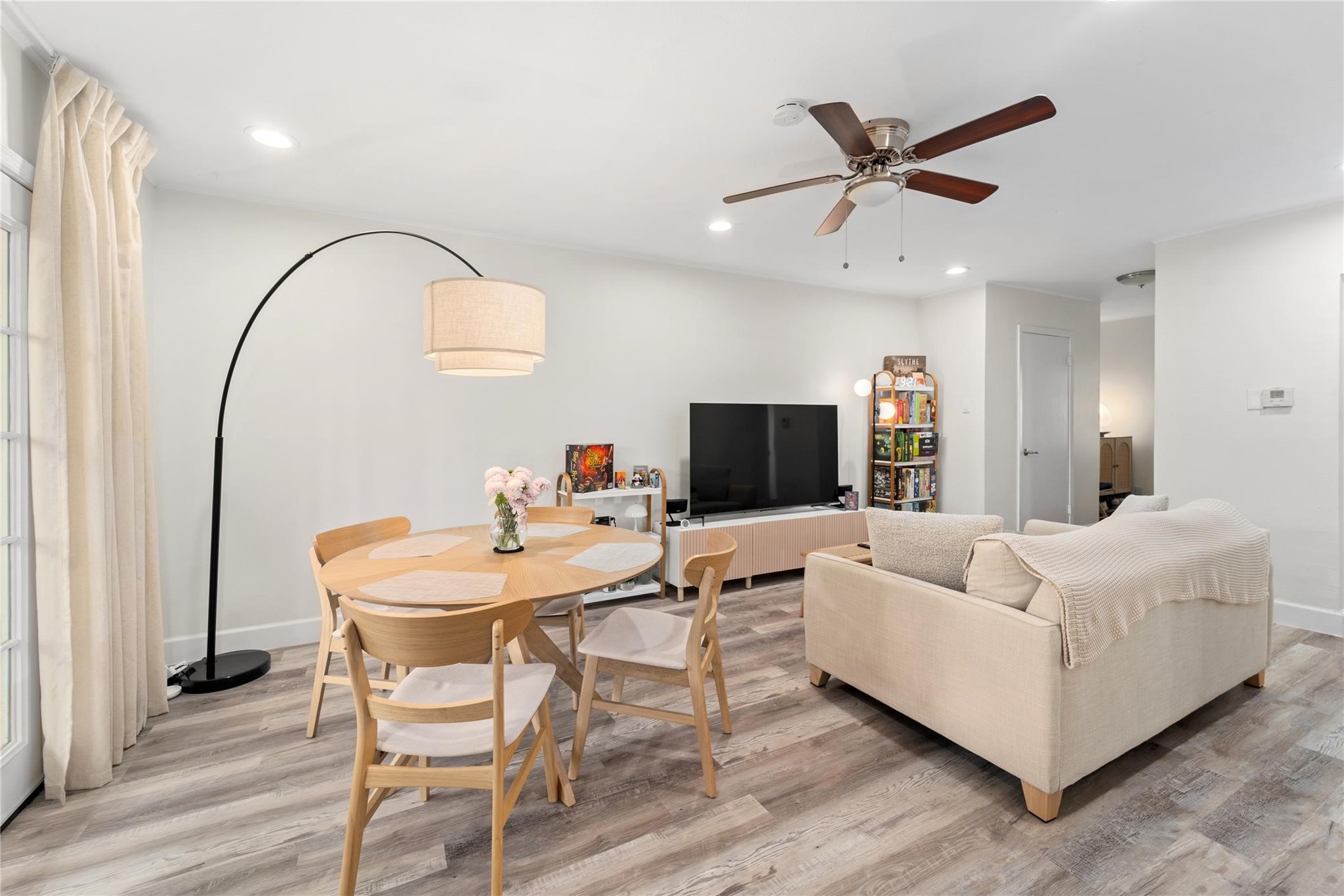 8223 Kingsbrook Road, Unit 212 Houston, TX 77024 - Photo 3 of 10 a living room with furniture and a flat screen tv