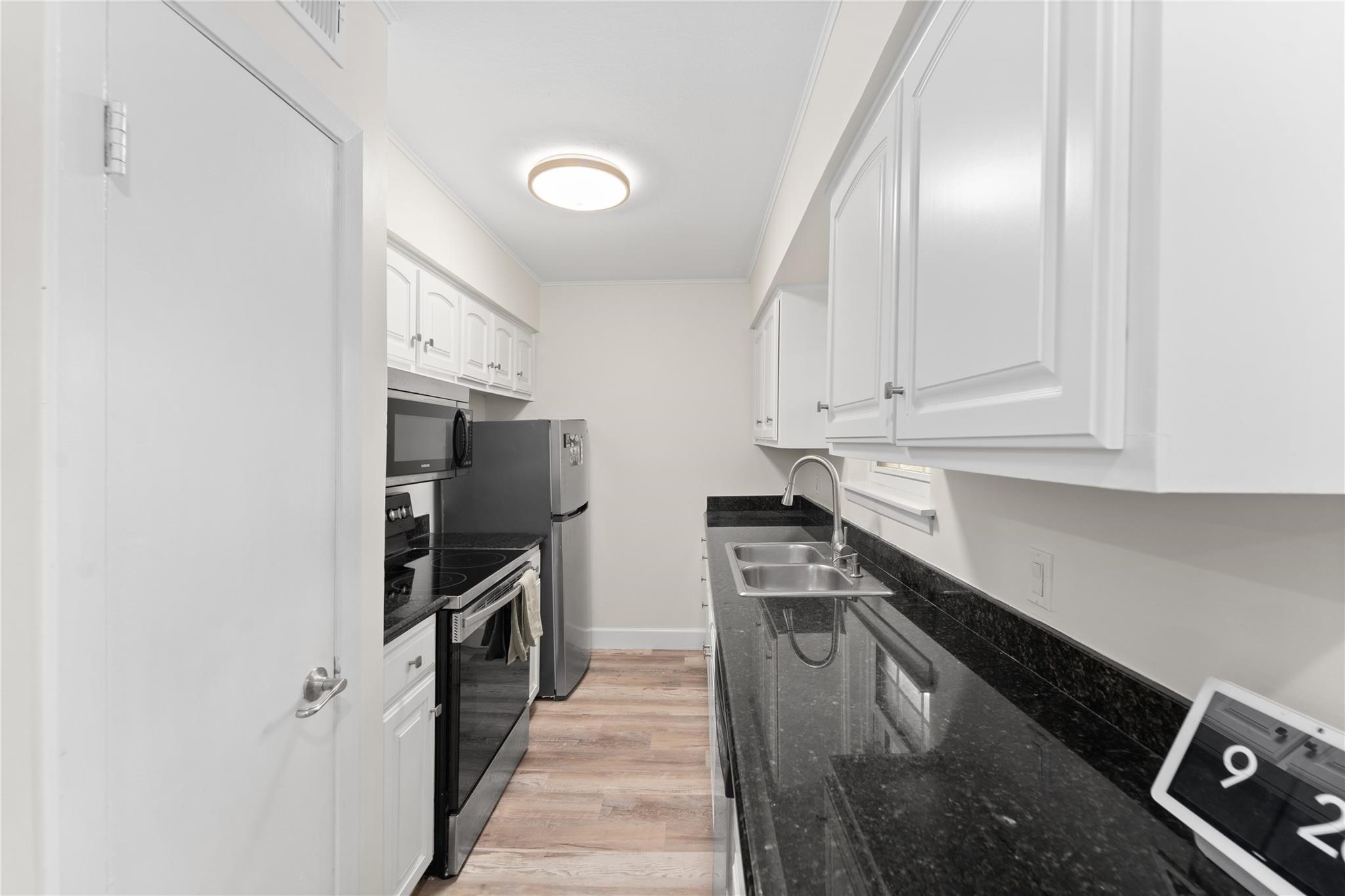 8223 Kingsbrook Road, Unit 212 Houston, TX 77024 - Photo 4 of 10 a kitchen with a sink appliances and cabinets