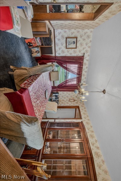 8675 West Smith Road Medina, OH 44256 - Photo 12 of 25 Dining area featuring patterned wallpaper and wood trim