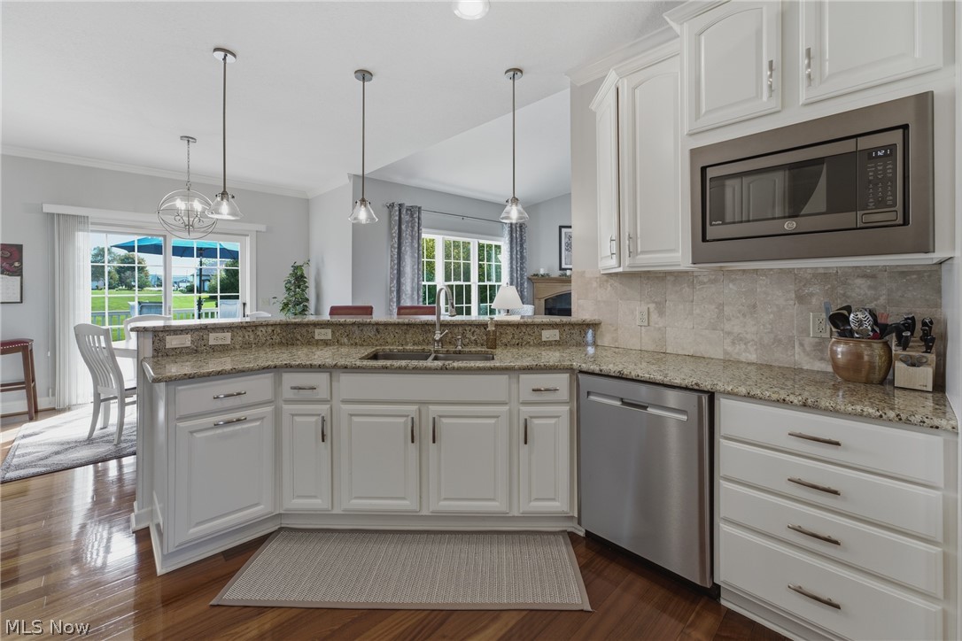 3955 Spring Brook Way Wooster, OH 44691 - Photo 11 of 50 Kitchen featuring white cabinetry, granite countertops, stainless steel appliances, and wood-finish flooring