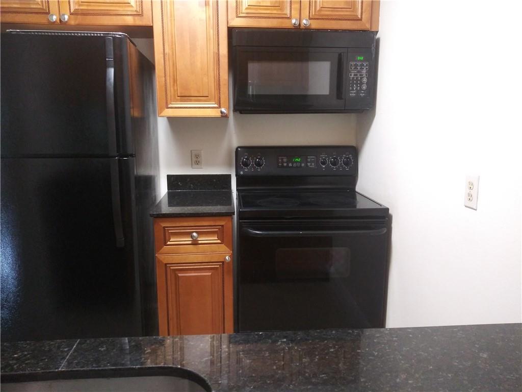 4200 Inverrary Boulevard, Unit 3306 Lauderhill, FL 33319 - Photo 1 of 4 a kitchen with a stove and a microwave