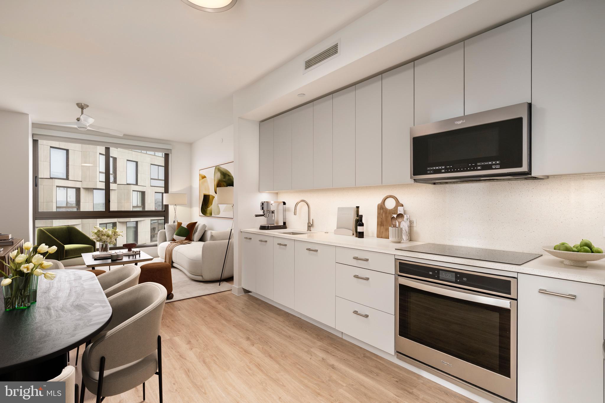 a kitchen with stainless steel appliances a stove sink microwave and cabinets