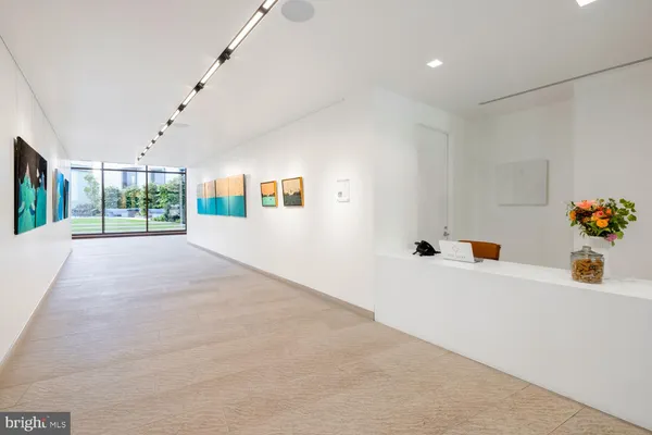 a living room with furniture and floor to ceiling windows