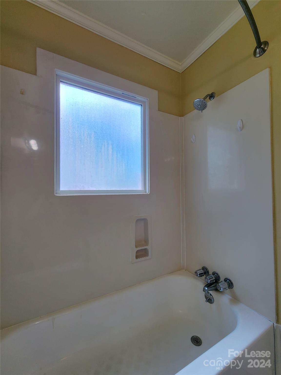 2117 Oakdale Road Charlotte, NC 28216 - Photo 13 of 20 a bathroom with a tub and a window