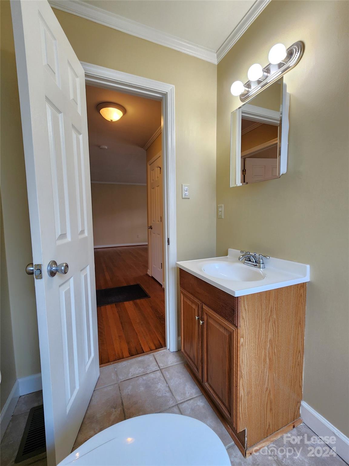 2117 Oakdale Road Charlotte, NC 28216 - Photo 14 of 20 a bathroom with a sink a mirror and a shower