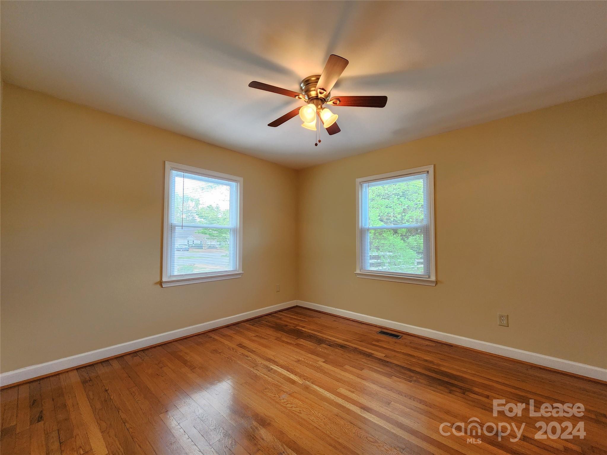 2117 Oakdale Road Charlotte, NC 28216 - Photo 15 of 20 a view of an empty room with wooden floor and a window