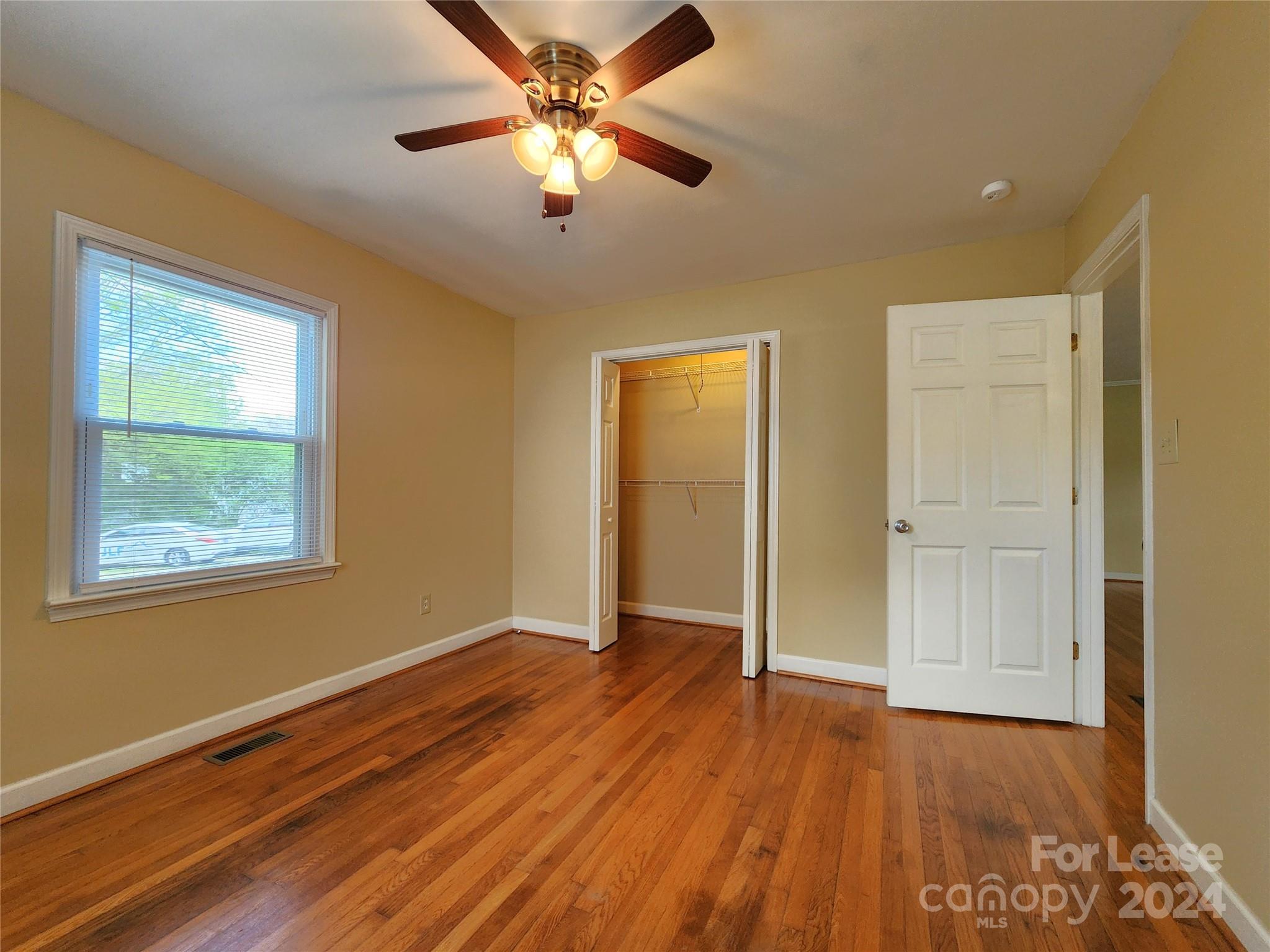 2117 Oakdale Road Charlotte, NC 28216 - Photo 16 of 20 a view of an empty room with wooden floor and a window
