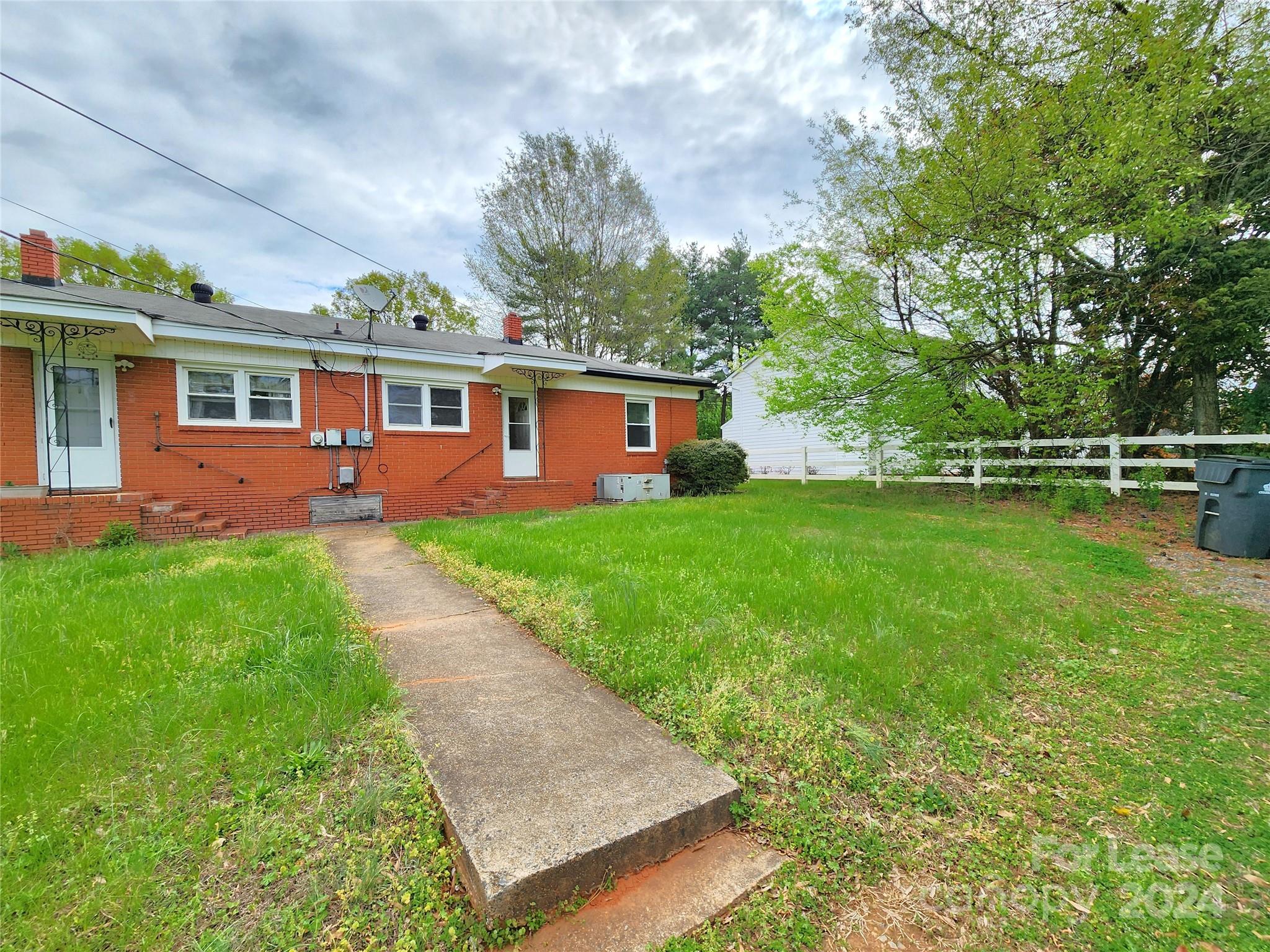 2117 Oakdale Road Charlotte, NC 28216 - Photo 18 of 20 a front view of house with yard and green space