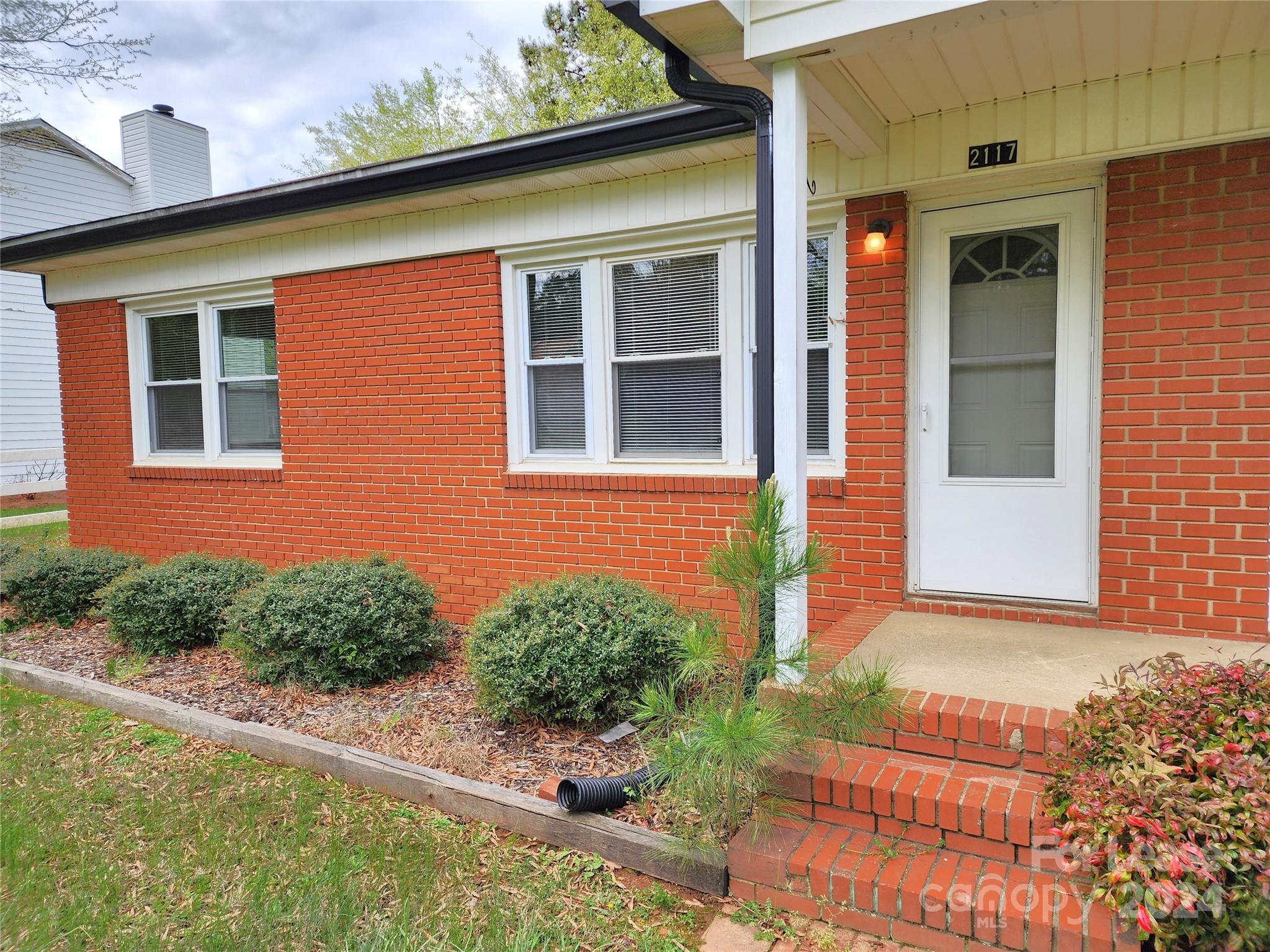 2117 Oakdale Road Charlotte, NC 28216 - Photo 2 of 20 a front view of a house with garden