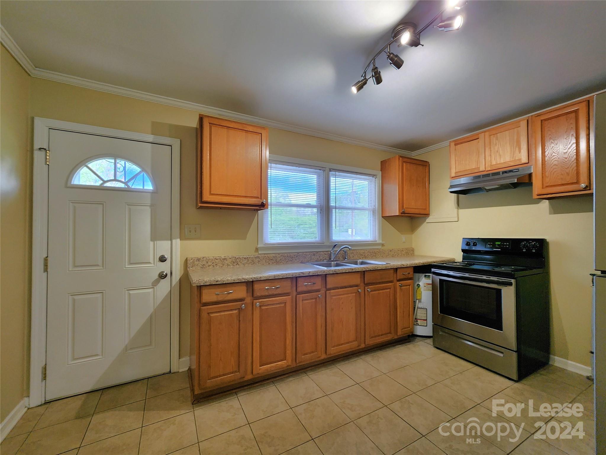 2117 Oakdale Road Charlotte, NC 28216 - Photo 4 of 20 a kitchen with stainless steel appliances granite countertop a stove sink and cabinets