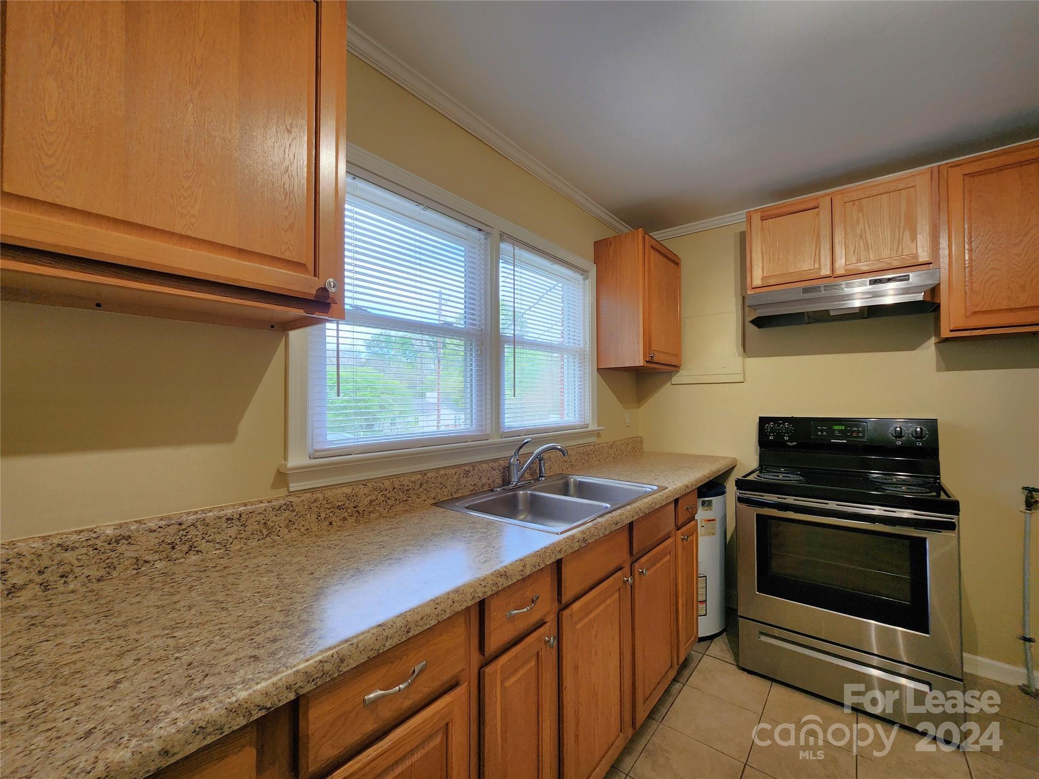 2117 Oakdale Road Charlotte, NC 28216 - Photo 5 of 20 a kitchen that has a sink and a stove