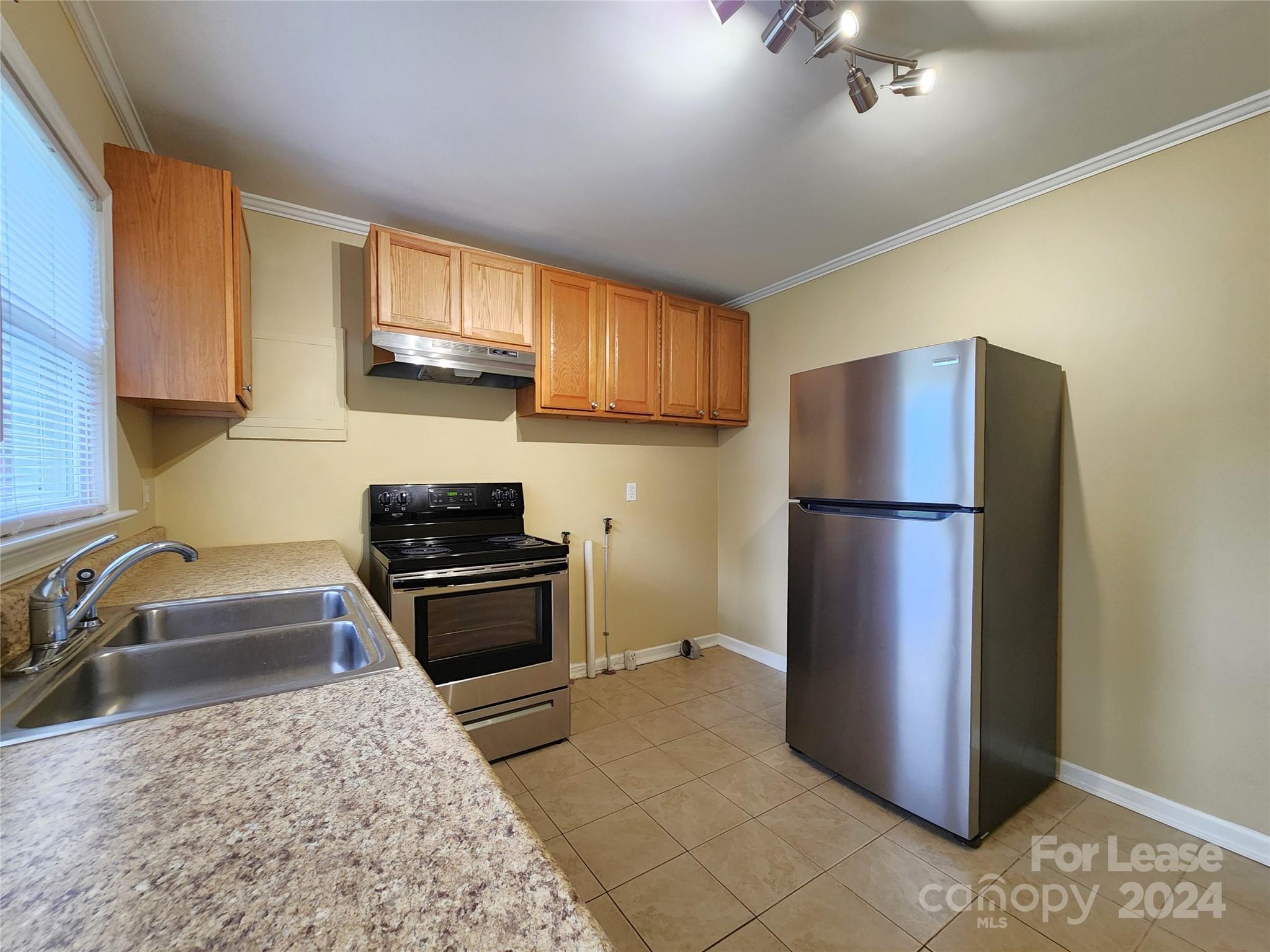 2117 Oakdale Road Charlotte, NC 28216 - Photo 6 of 20 a kitchen with a refrigerator sink and stove