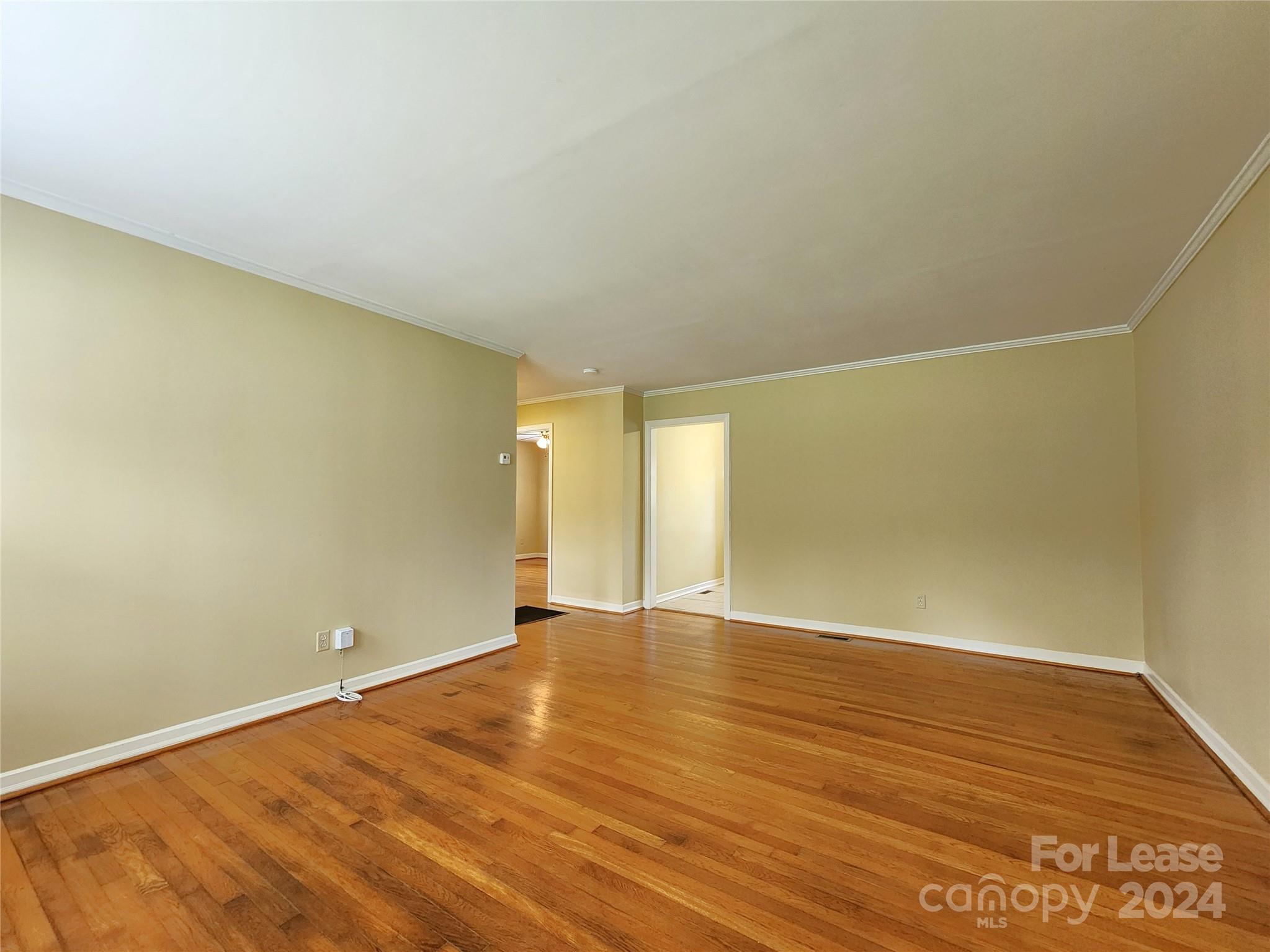 2117 Oakdale Road Charlotte, NC 28216 - Photo 7 of 20 a view of an empty room with wooden floor