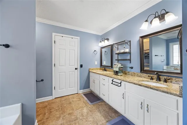 a spacious bathroom with a double vanity sink and a mirror