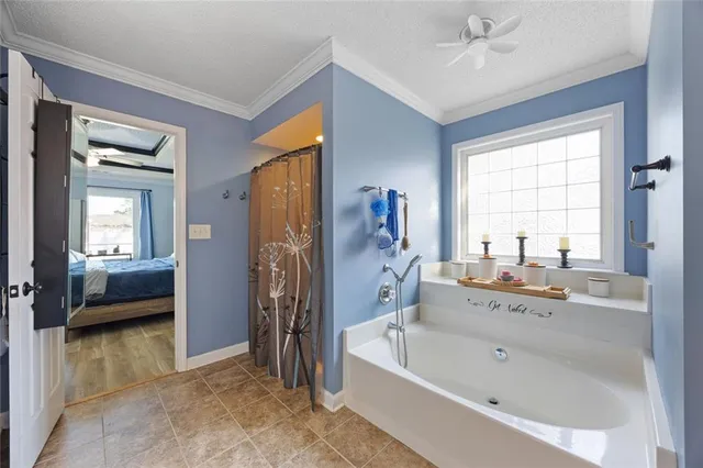 a bathroom with a tub a sink and a large mirror